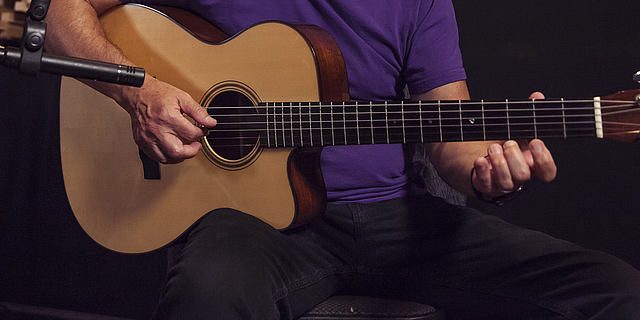 This image shows a LCT 140 small diaphragm condenser microphone on a Martin acoustic guitar