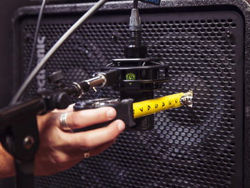 LEWITT microphone is getting positioned in front of bass amp
